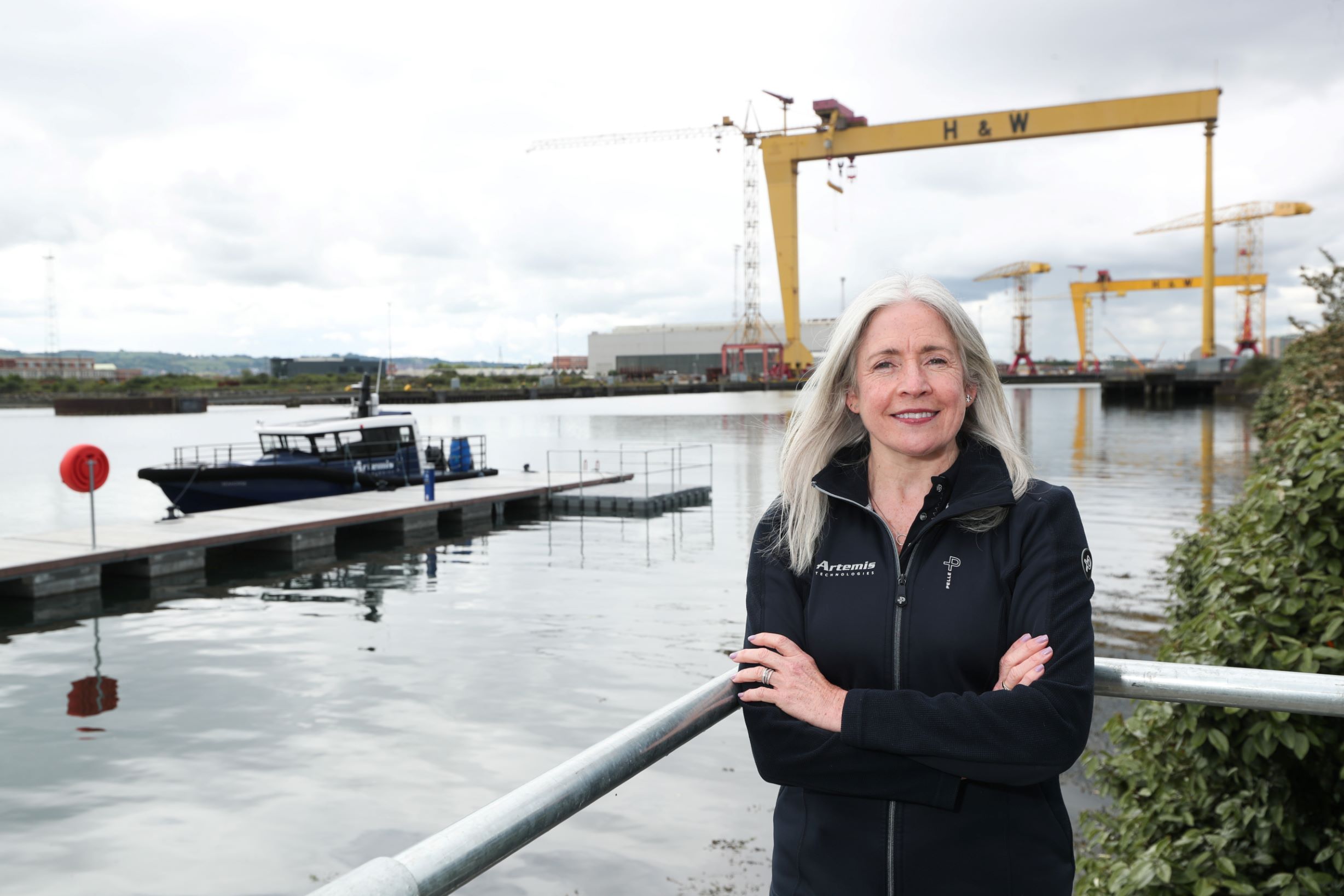headshot of Katrina Thompson infront of pontoon and Harland and Wolf cranes