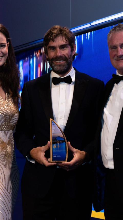 Iain percy holding award onstage with two others
