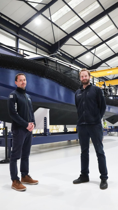 David Tyler and Romain Ingouf standing infront of Artemis Technologies EF-12 Workboat in new facility