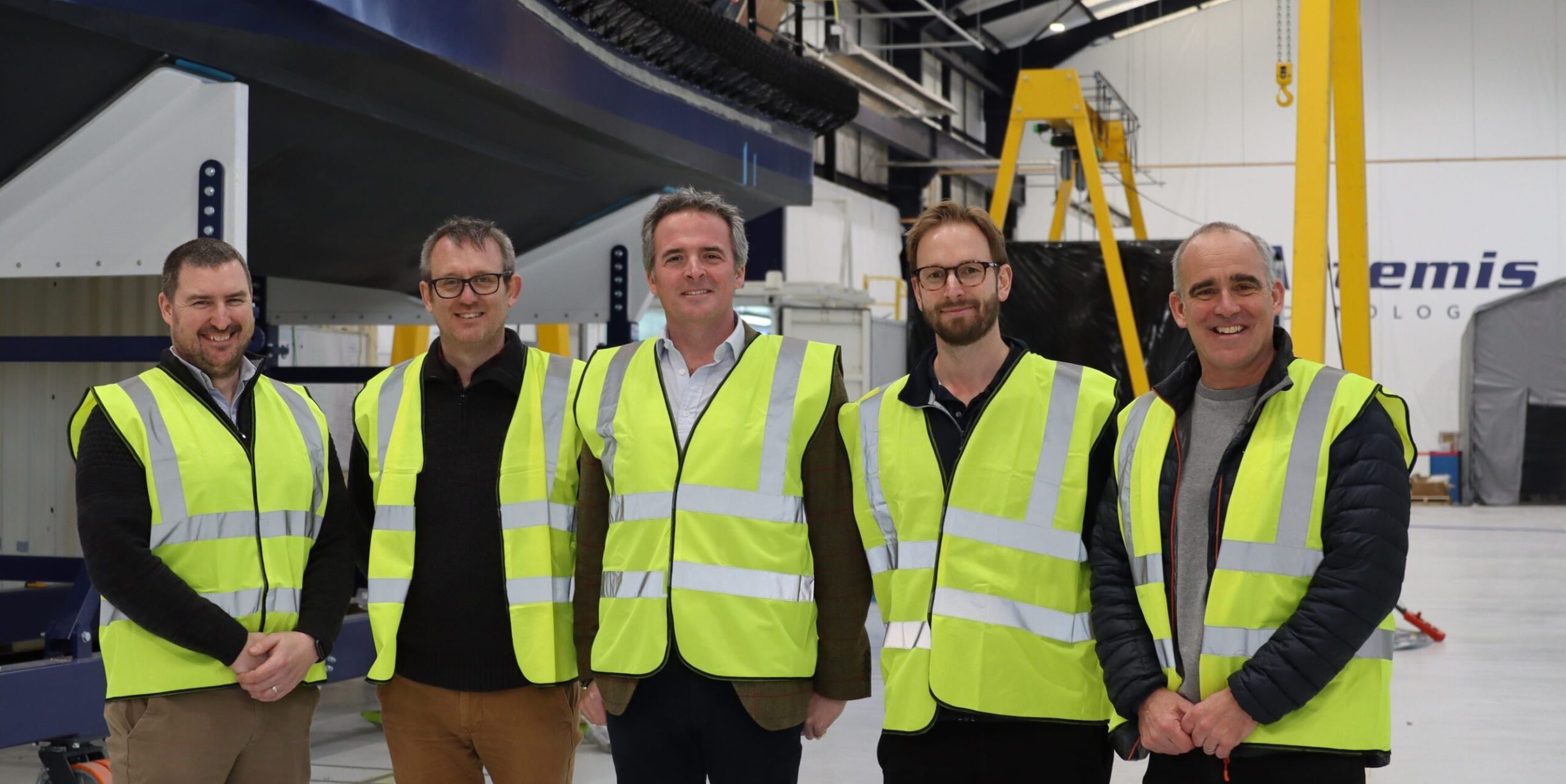 David Tyler with group from Tidal Transit in high visibility vests at manufacturing facility
