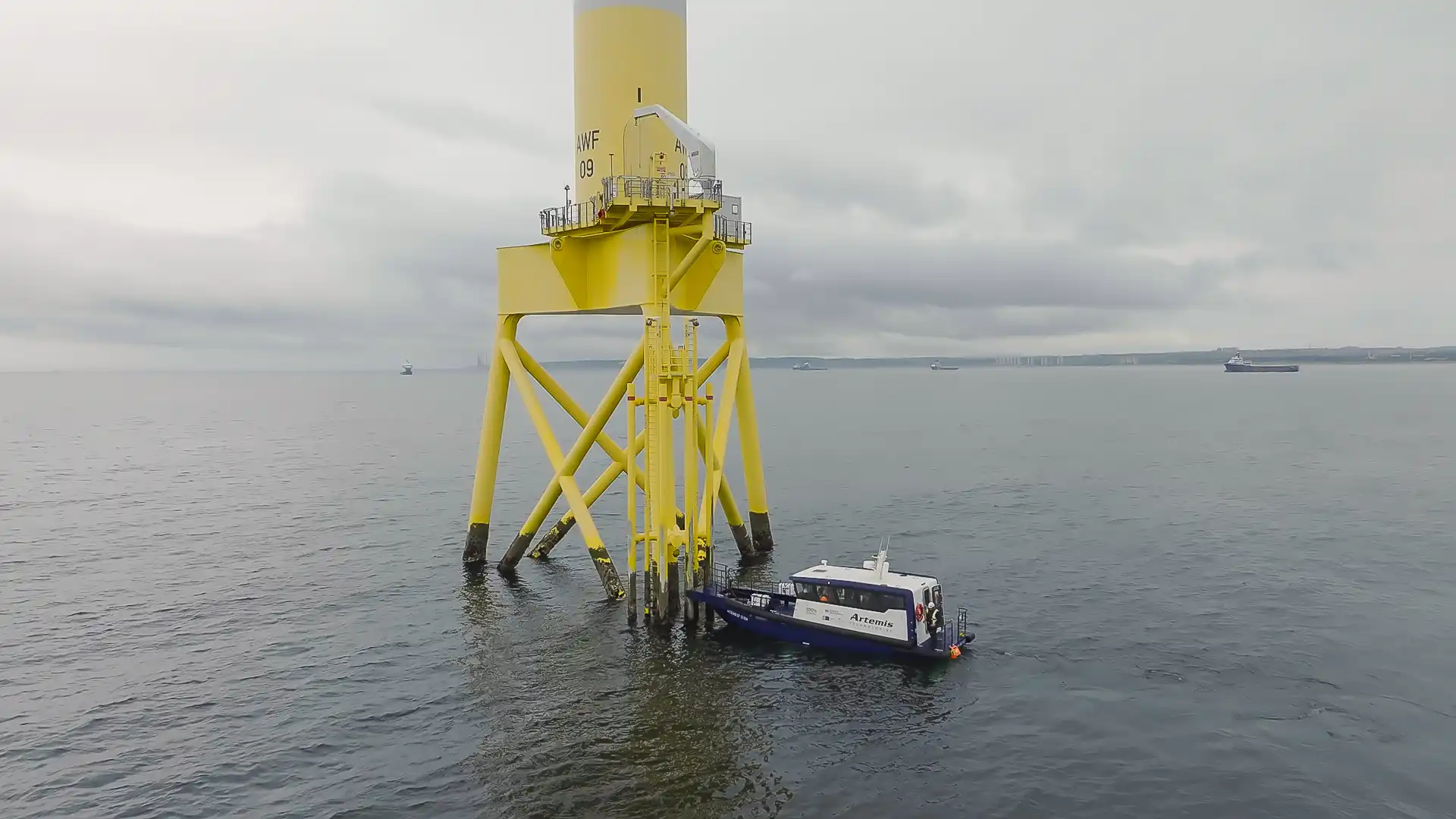 Artemis EF-12 CTV in non-foiling mode with the bow fender up against the wind turbine completing a bollard push manoeuvre. 