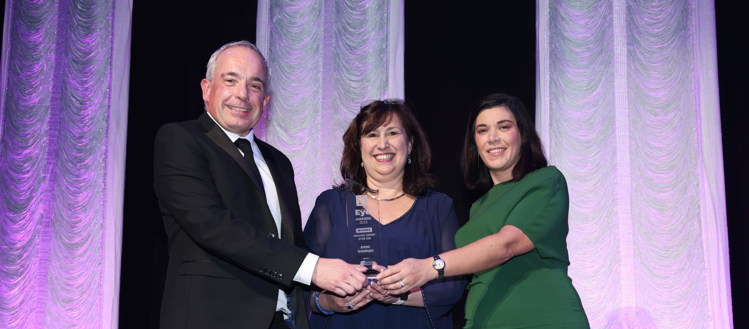 Debbie Eve holding award alongside Keira McSorley and one other