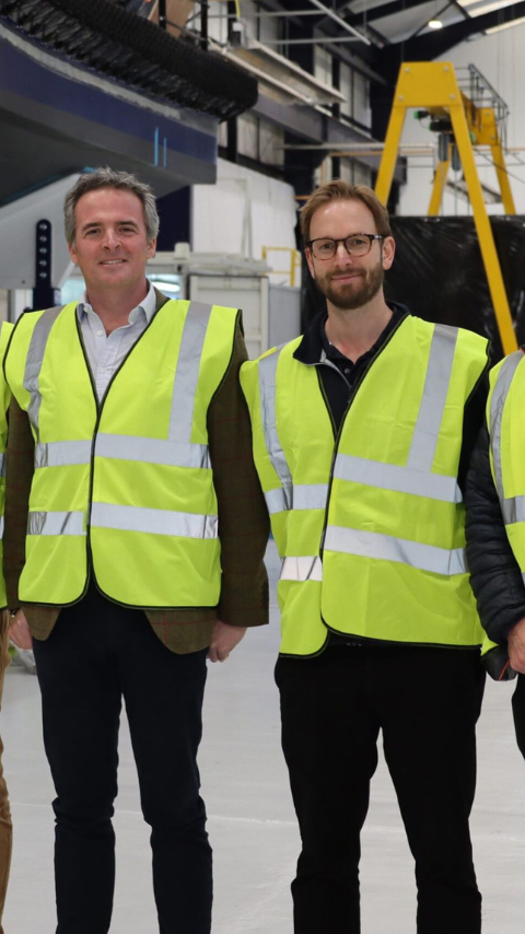 David Tyler with group from Tidal Transit in high visibility vests at manufacturing facility