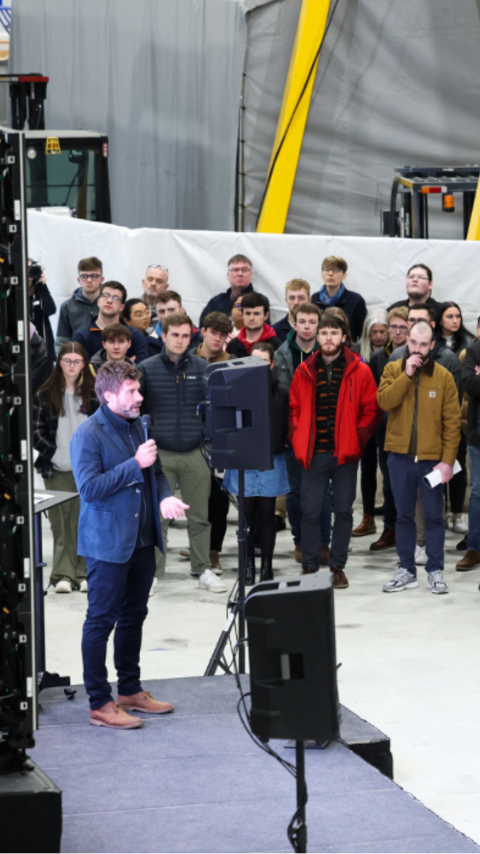 Iain Percy onstage addressing careers open evening audience