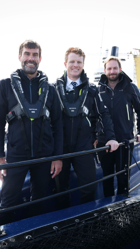 Joe Kennedy, Iain Percy and David Tyler standing on deck on Artemis Technologies EF-12 Workboat