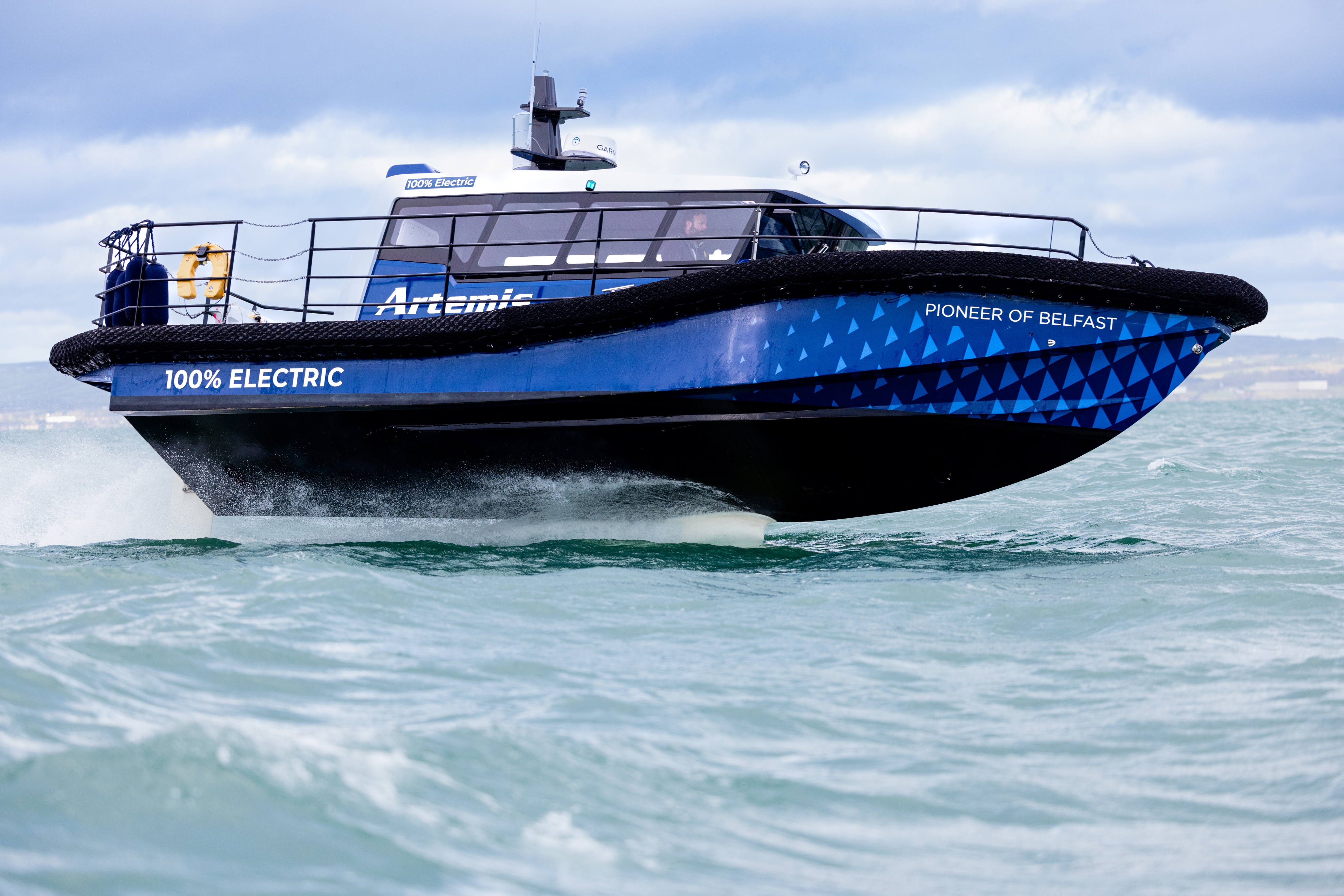 Close up of the Artemis EF-12 Workboat doing a turn while foiling