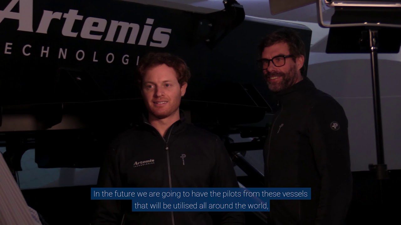 Iain Percy with one other standing infront of rtemis Technologies Simulator