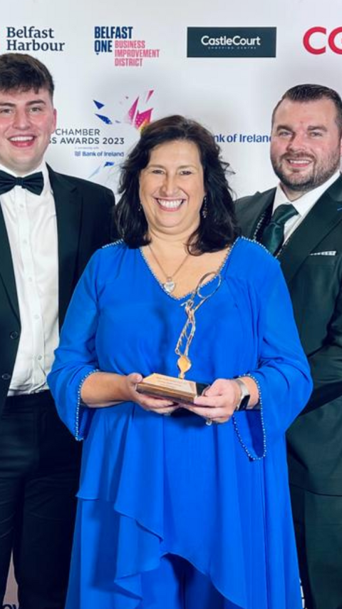 Debbie eve with three other Artemis Technologies employees holding award