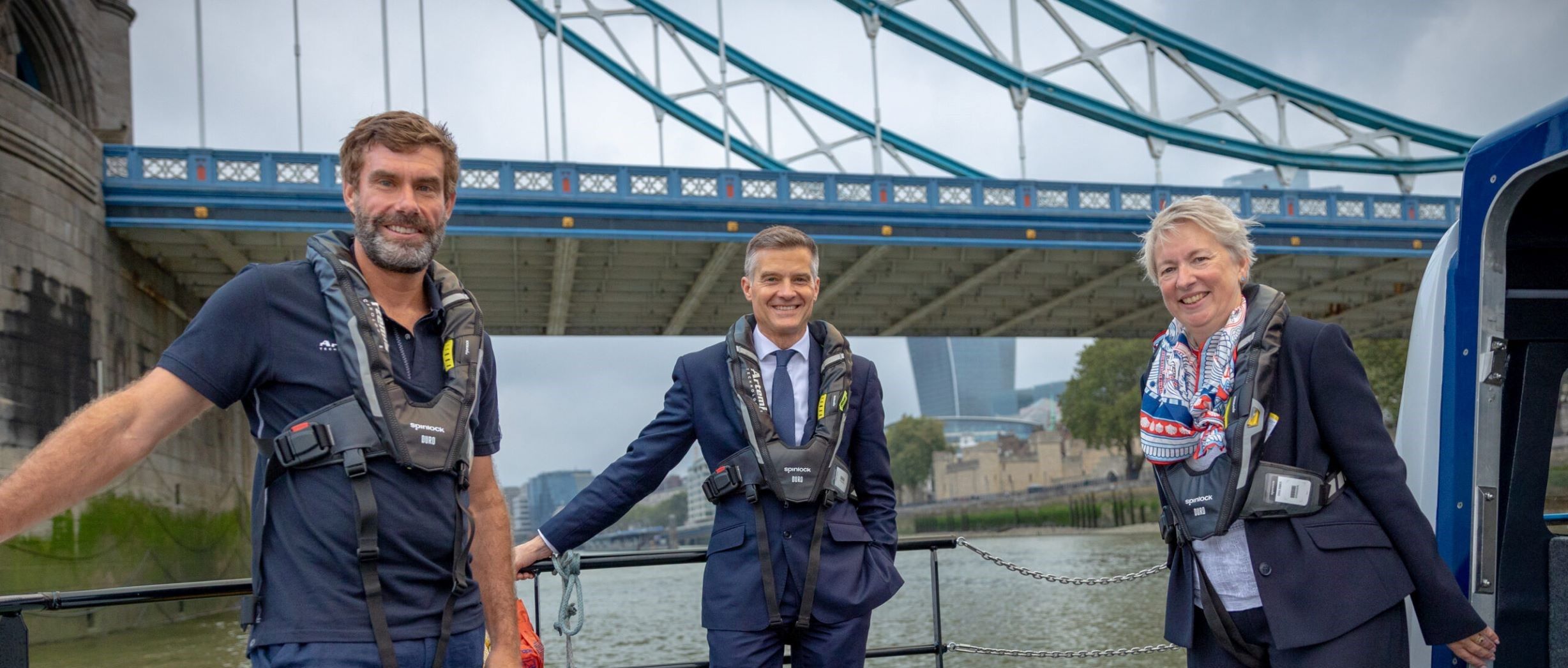 Iain Percy standing with two others on pioneer under London Bridge