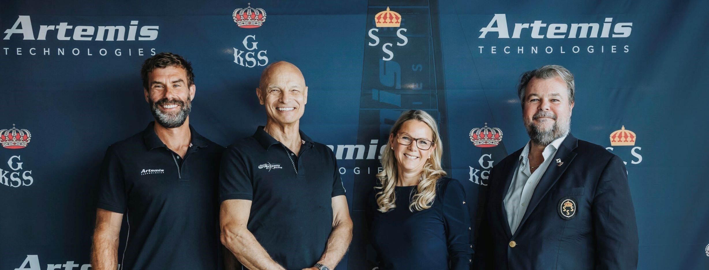 Iain Percy with three others infront of logo backdrop