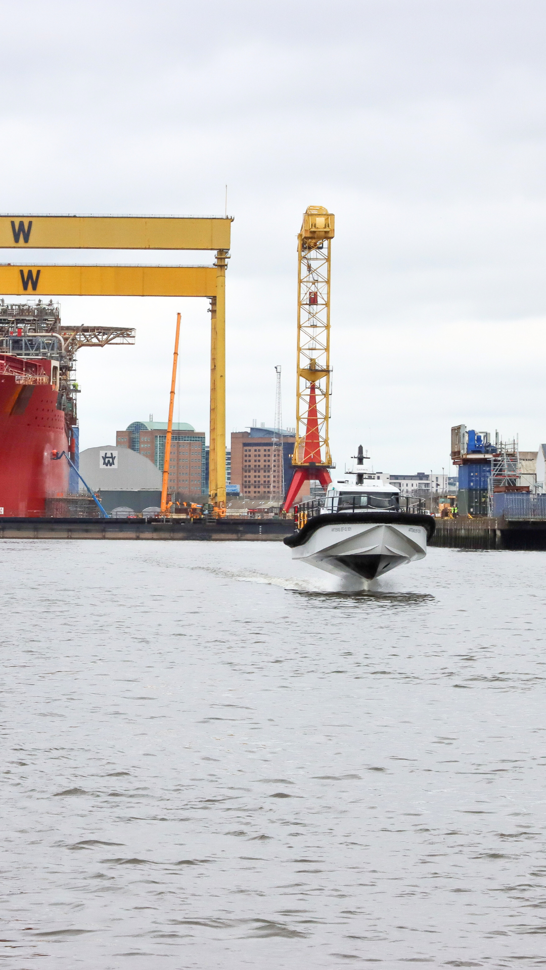 White workboat foiling in Belfast Harbour