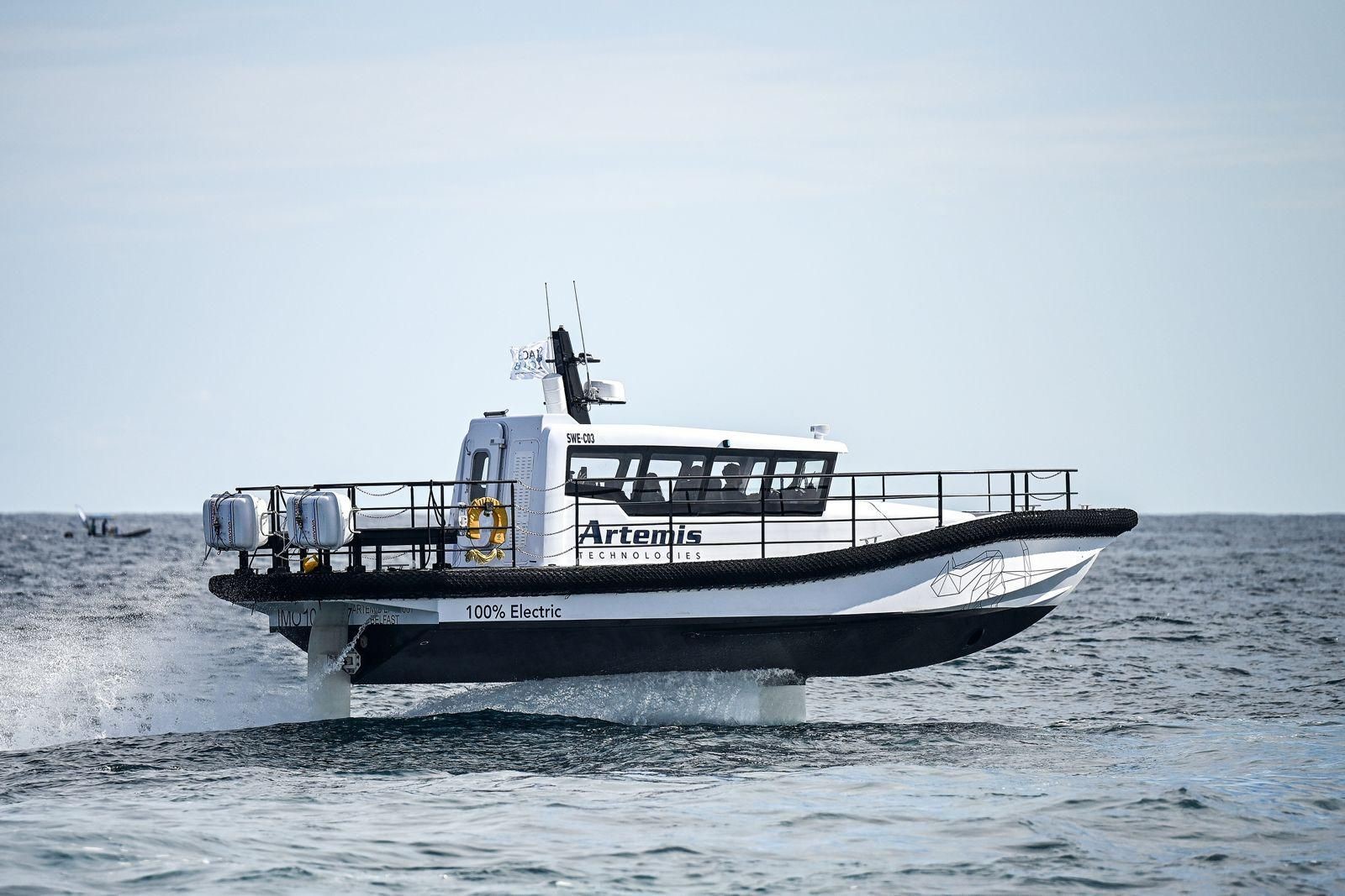 White Artemis EF-12 Workboat foiling in Barcelona in the sunshine