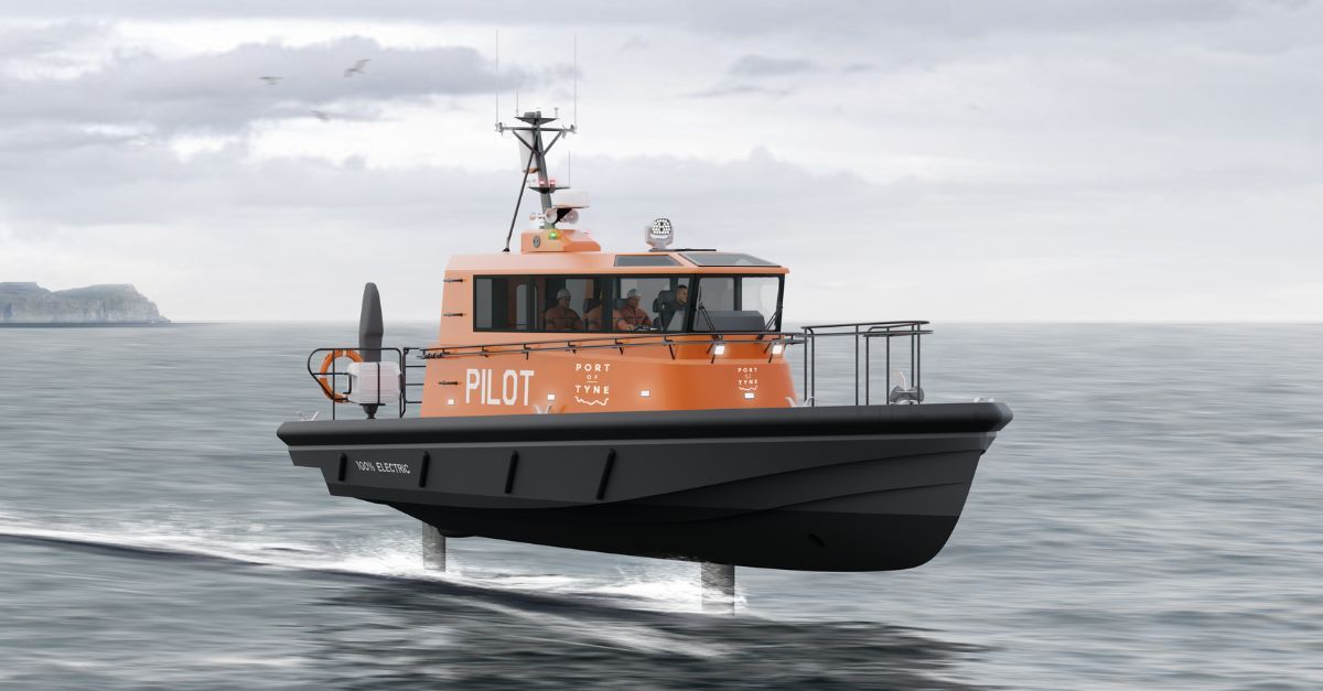 Port of Tyne white logo on the side and front of the 100% electric foiling orange Artemis EF-12 Pilot boat's wheelhouse. With a headland in the background and a grey sky