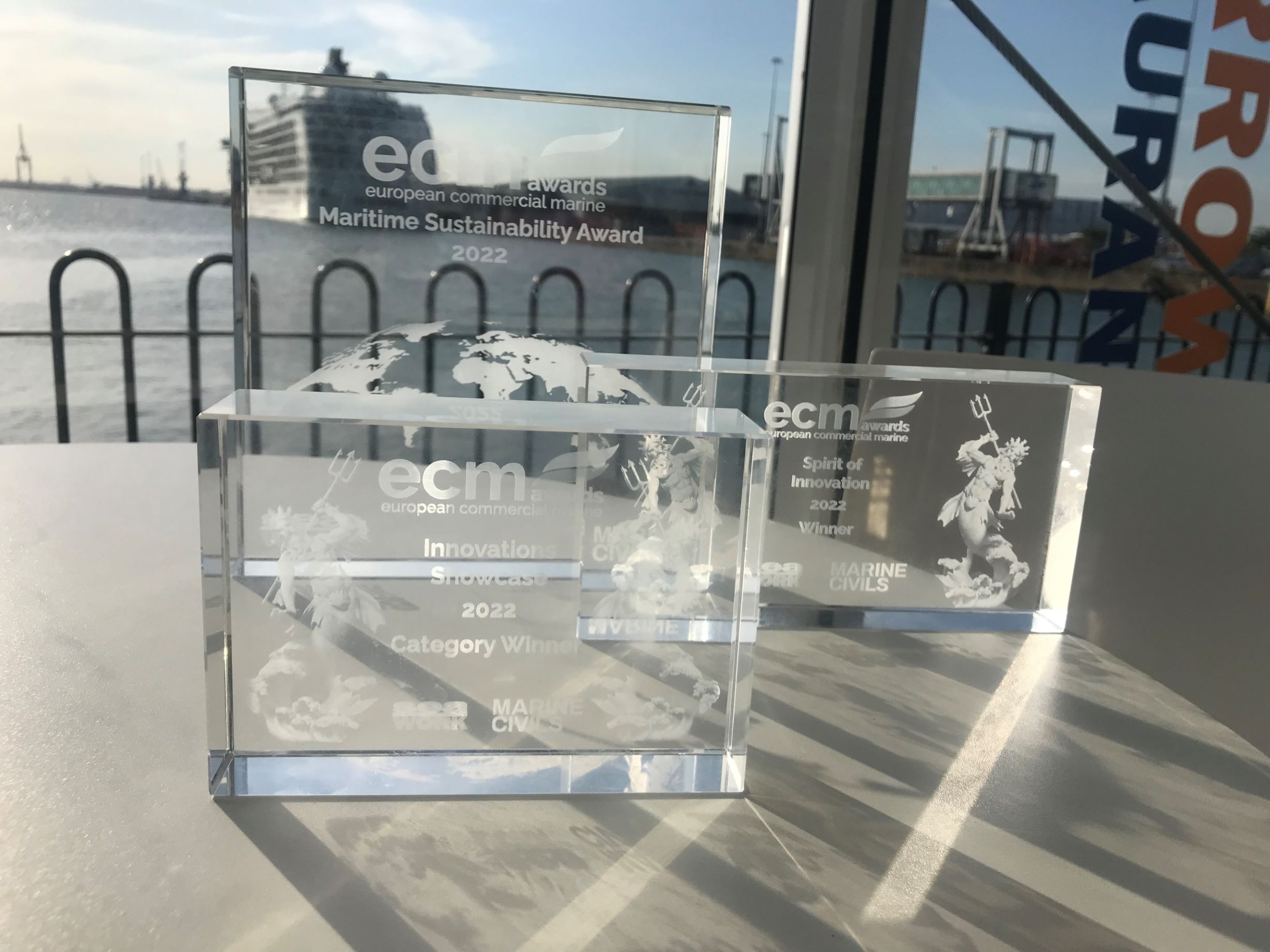 three glass awards on display in Artemis Technologies main office
